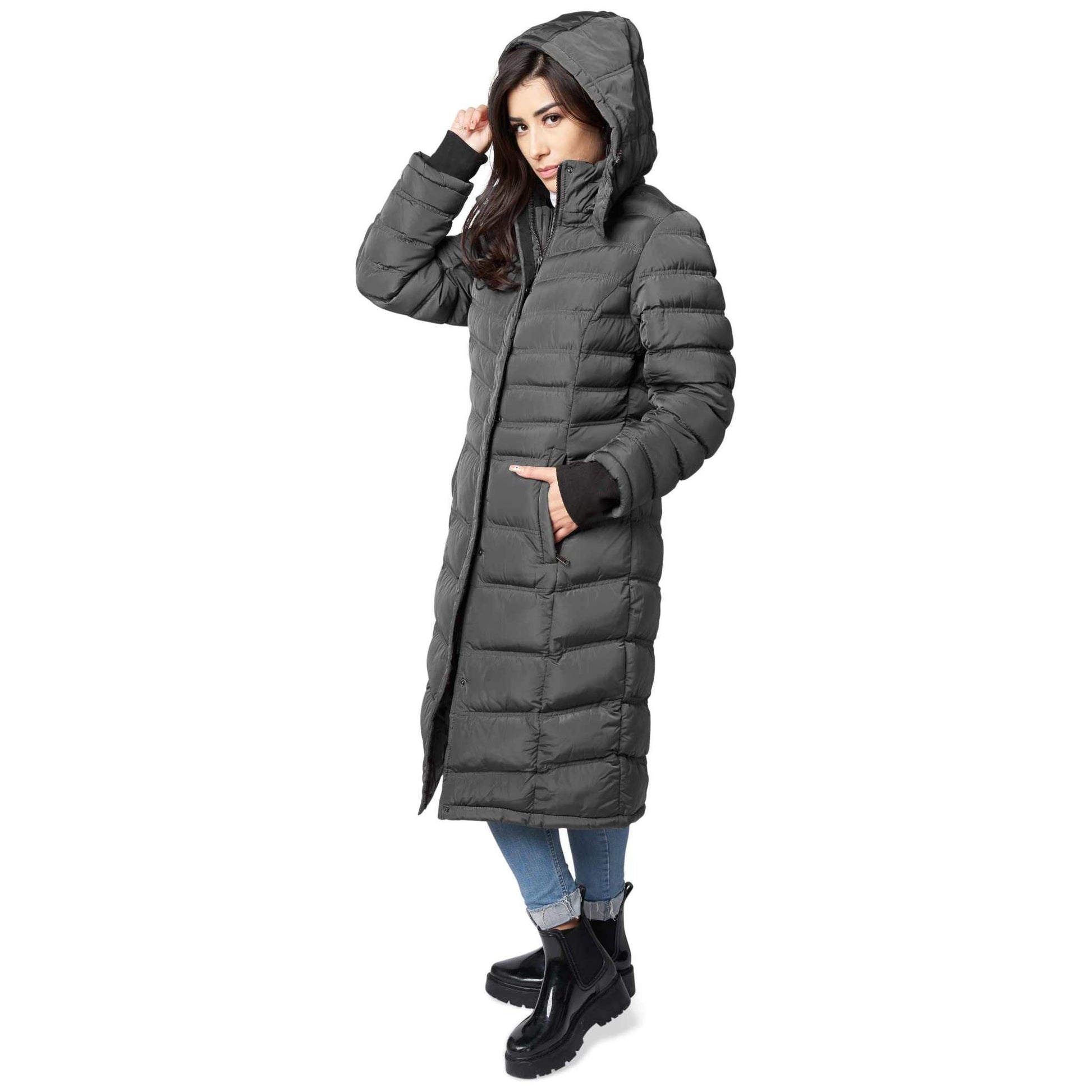 Woman wearing Elora Maxi Puffer coat with hood, showcasing warm winter style.